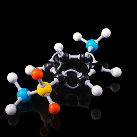 Ball-and-stick molecular model against a black background showing atoms connected by bonds.