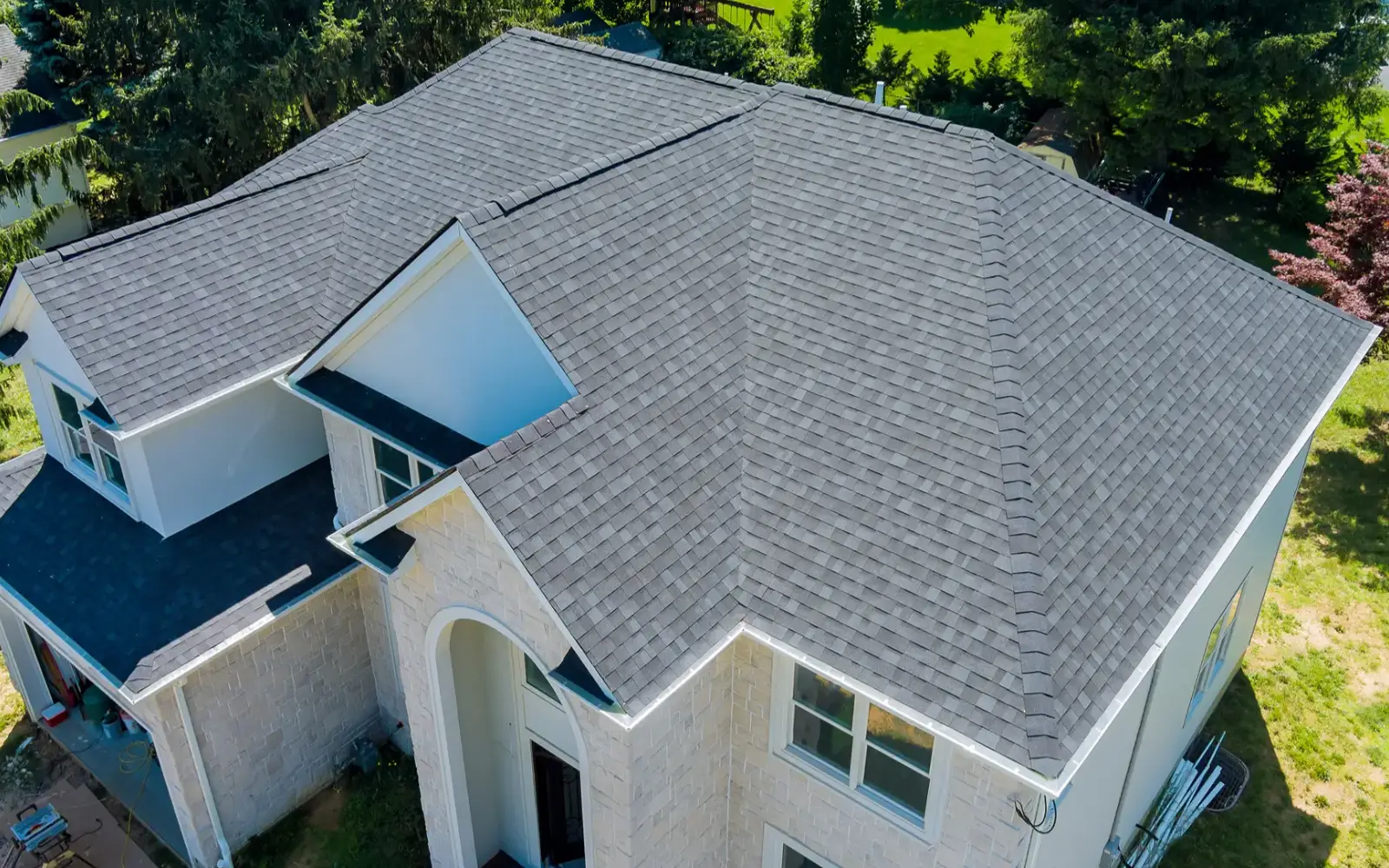 Roofing services promotional banner showing home roof and contractor work for professional roofing replacement and repair.