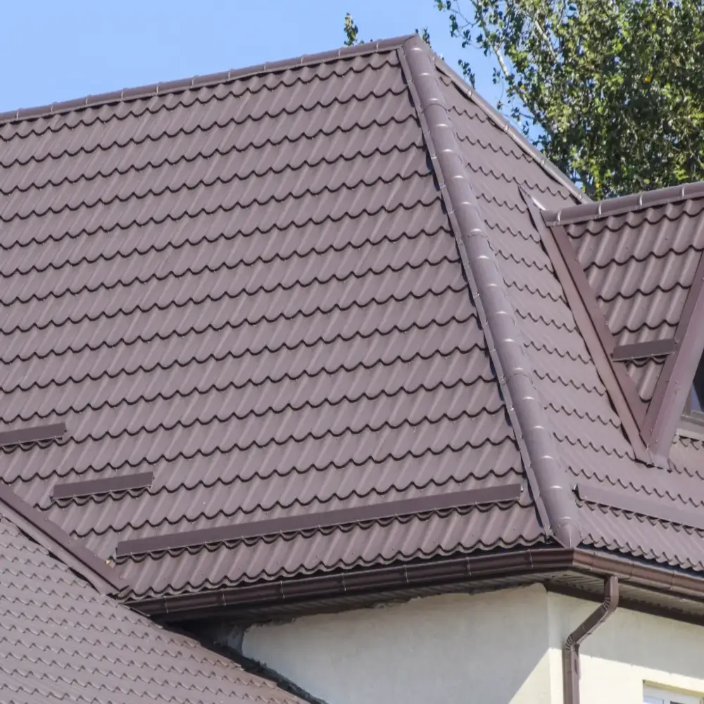 Metal roofing installation on home exterior showcasing durable metal roof panels for professional roofing services.