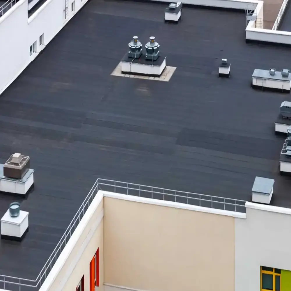 Flat roofing installation on commercial or residential building exterior showcasing professional flat roof services.