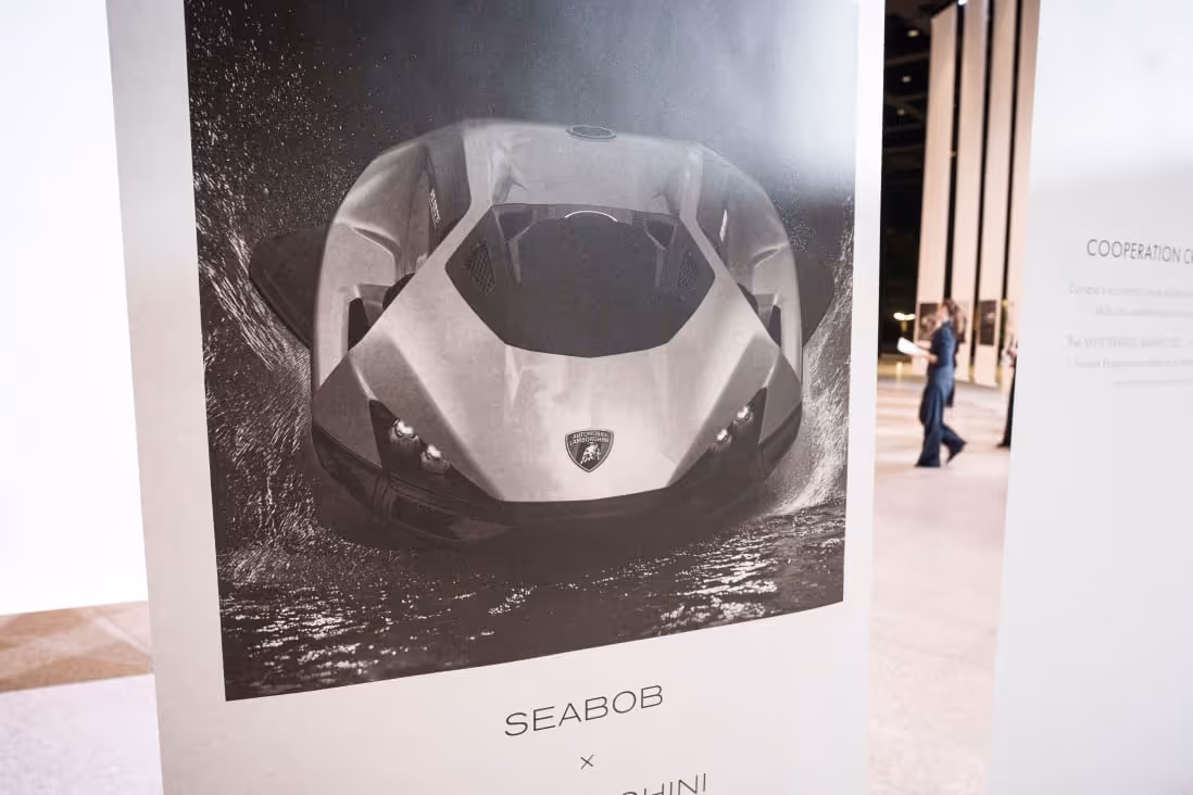 Poster of a sleek Seabob water vehicle with a Lamborghini emblem, displayed indoors.