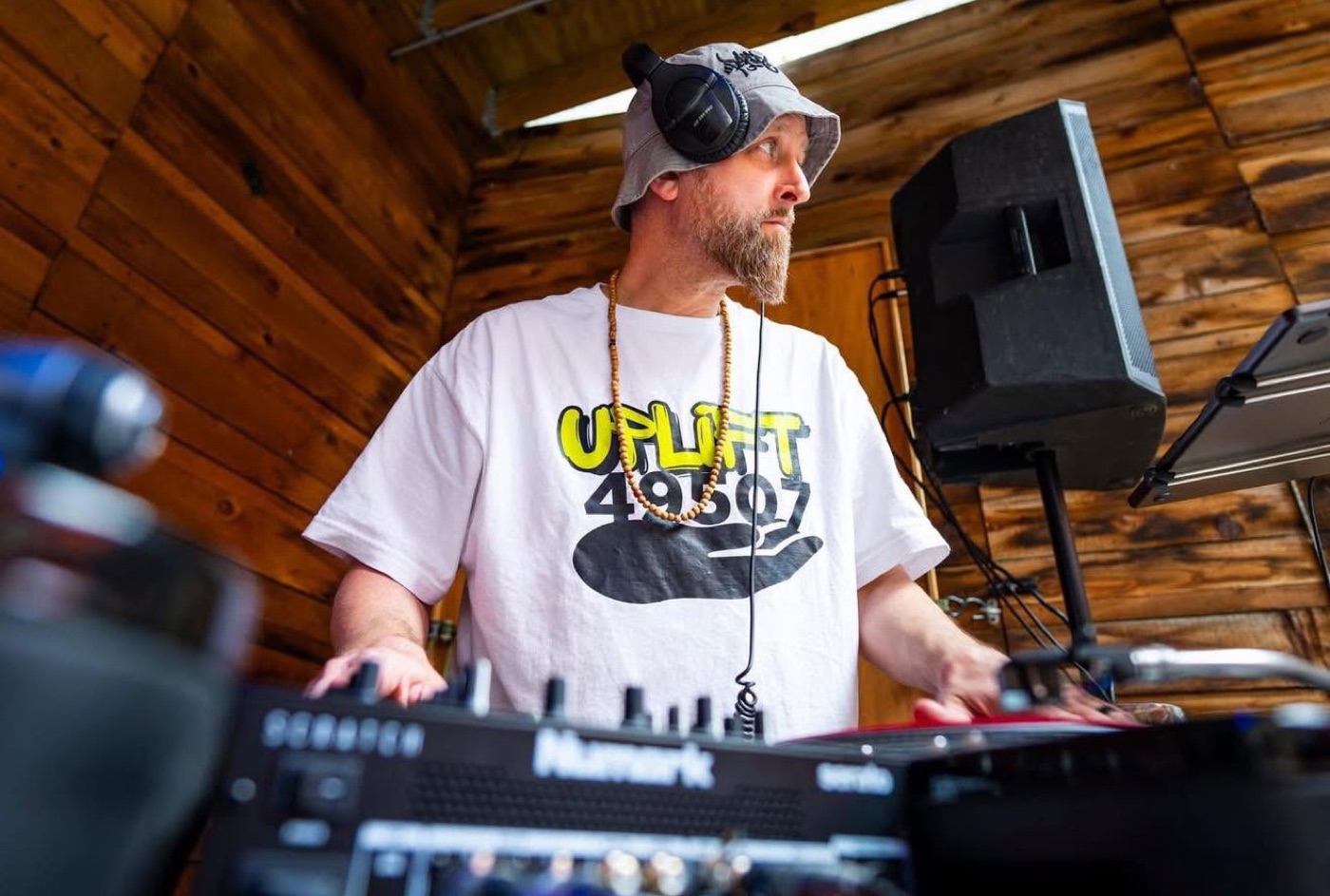 Matt “Monk” Duncan DJing in an Uplift 49507 shirt