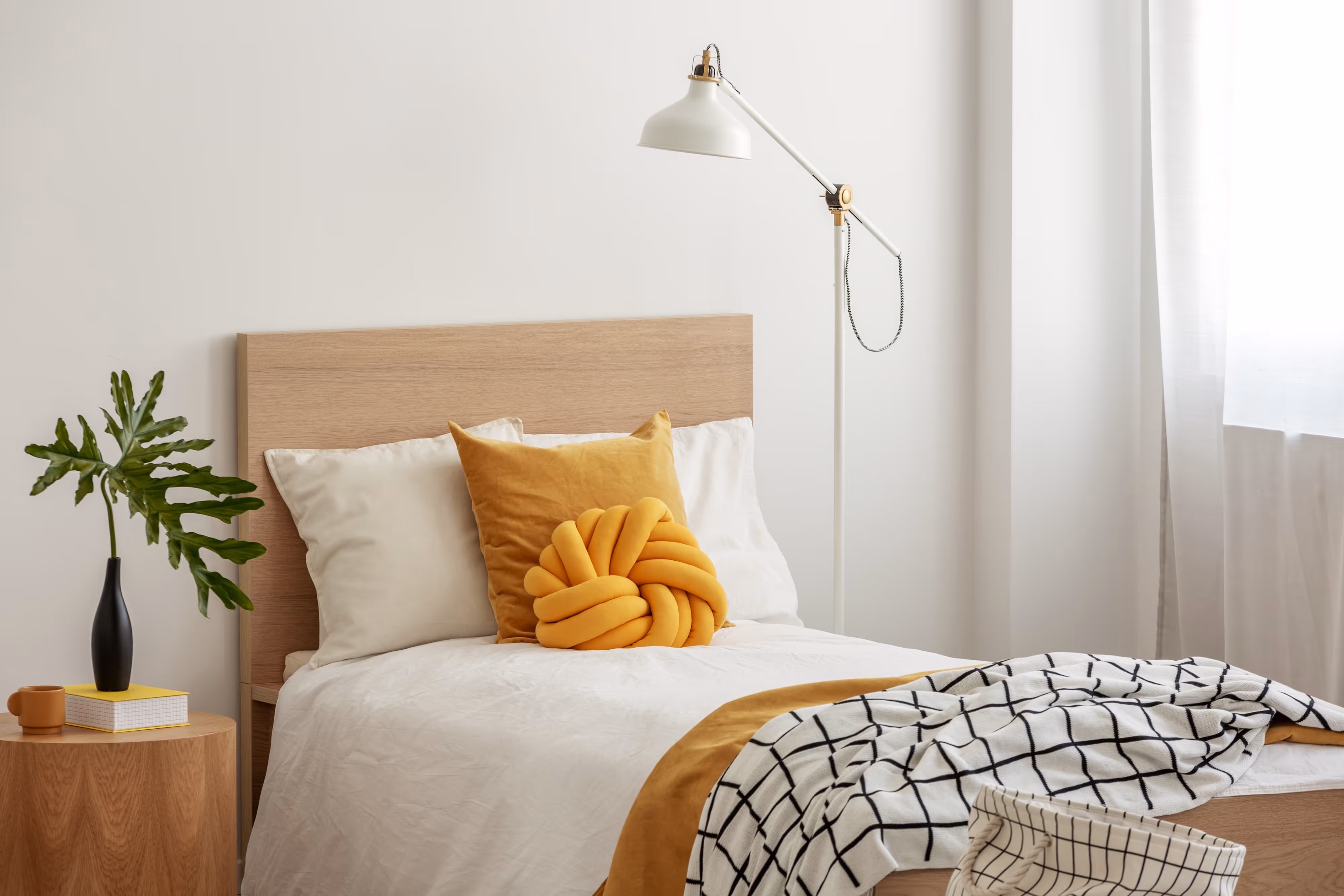 Bed with Yellow Pillow Stock Photo