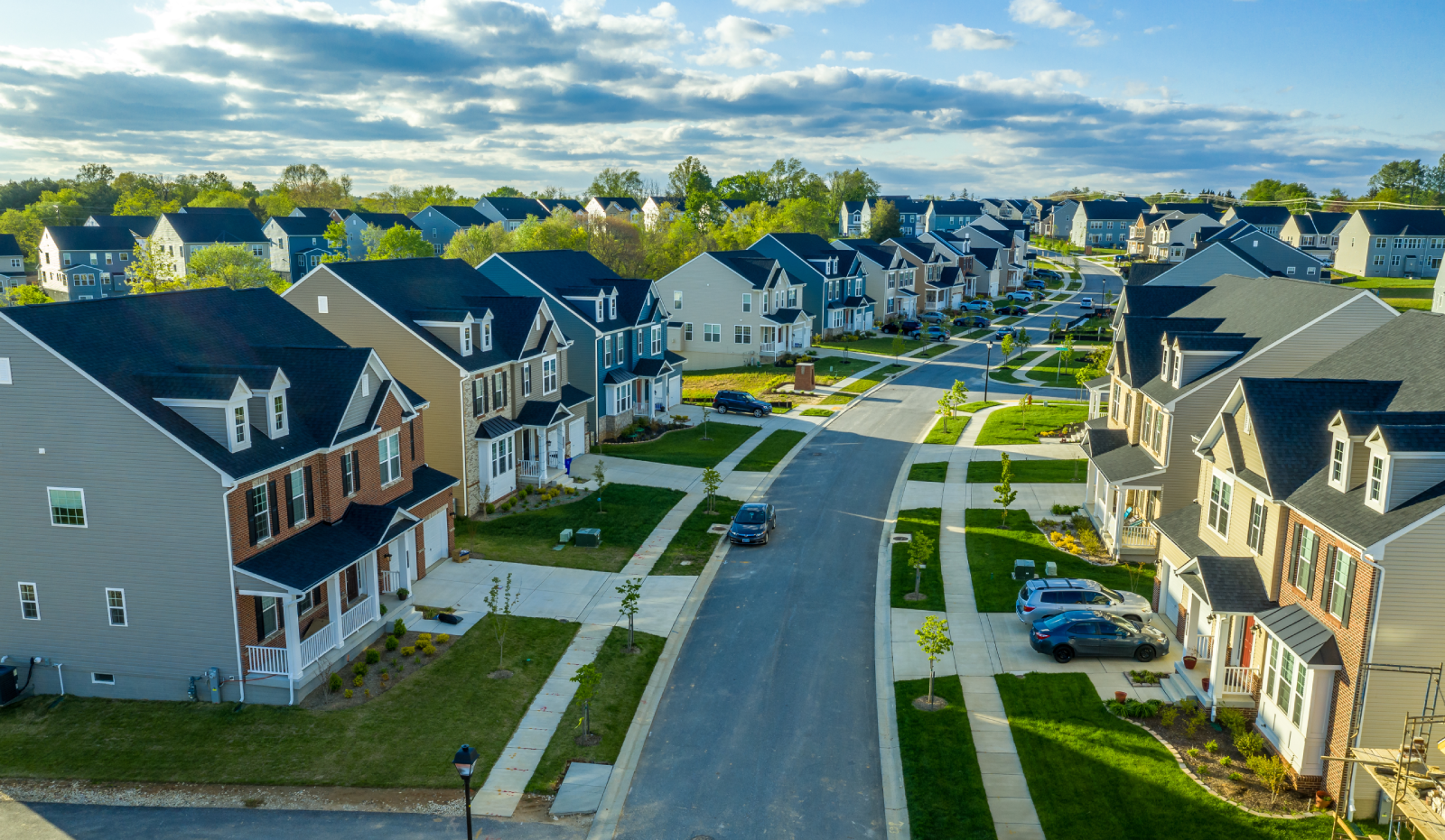 Aerial view of a suburban street lined with new townhomes