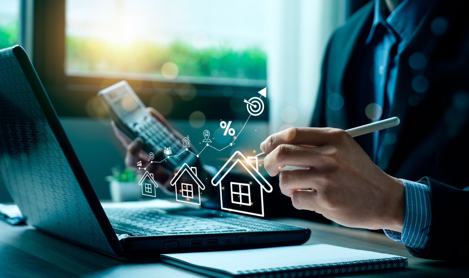 Hand pointing at house icons above a laptop keyboard