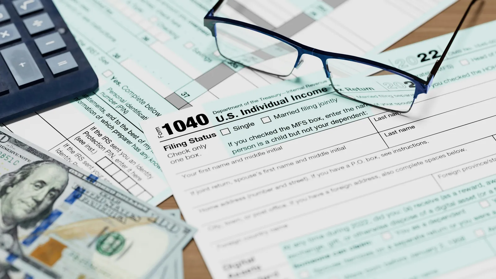 Reading glasses resting on top of a tax form