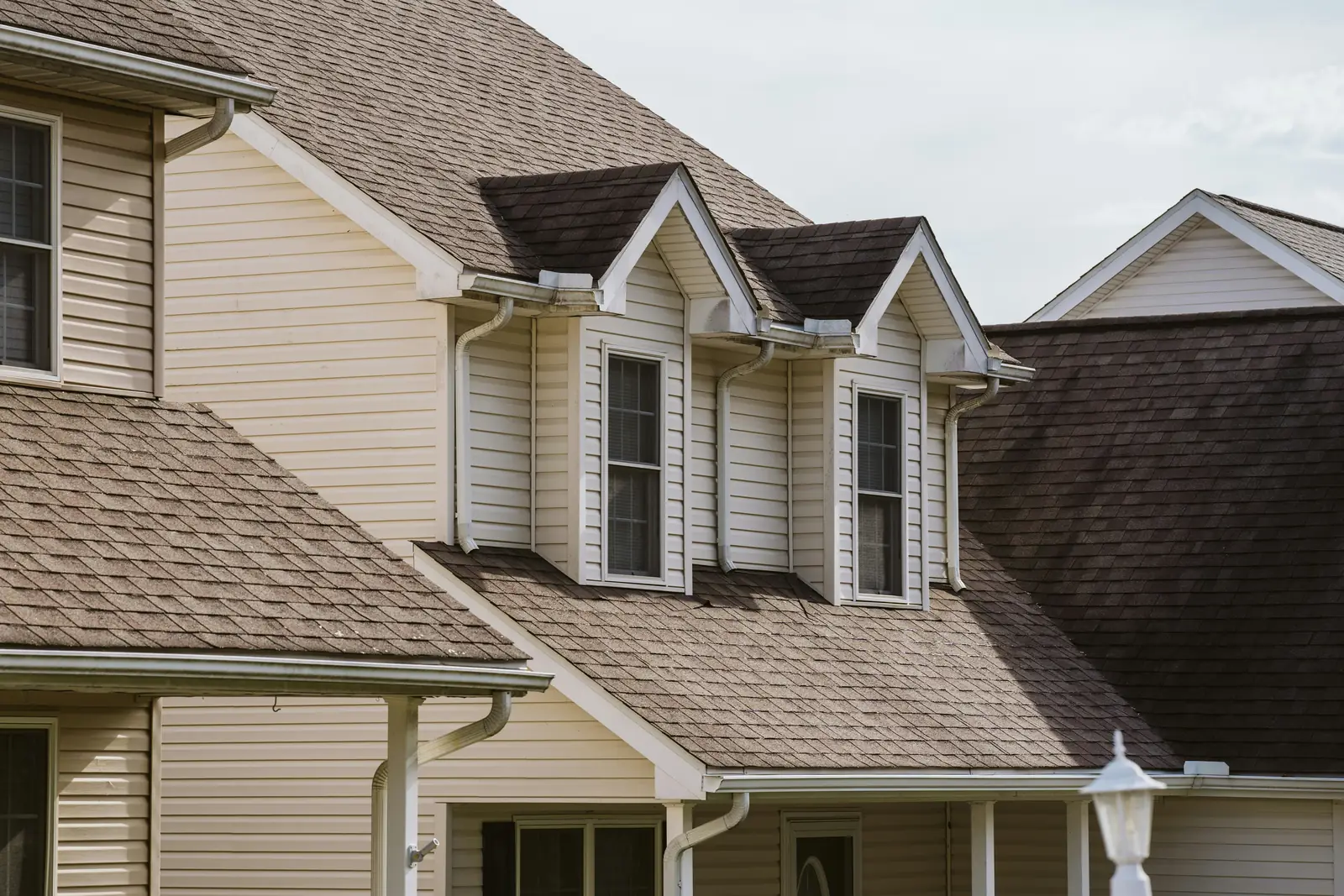 Rooflines of neighboring suburban homes with dormer windows