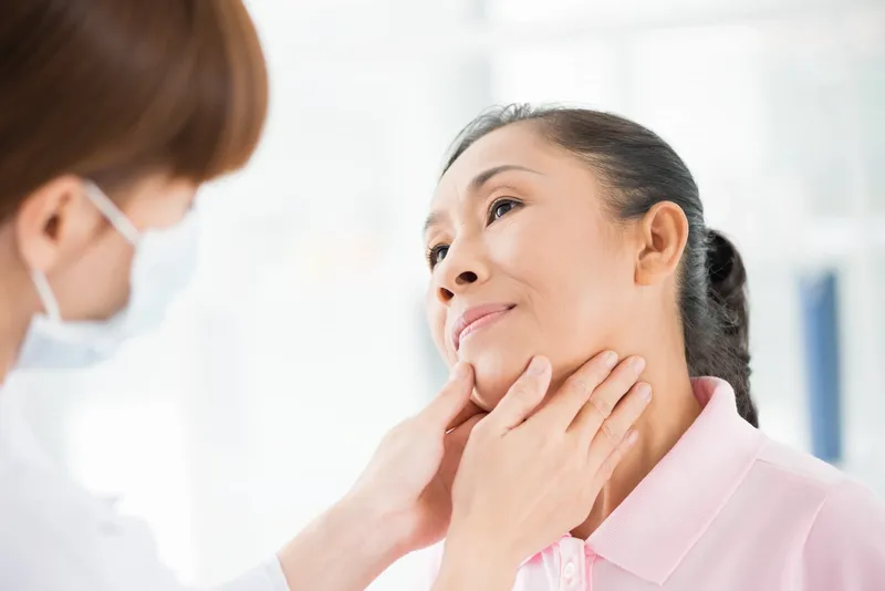Doctor checking thyroid