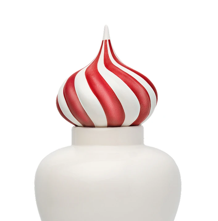 White ceramic jar with a red and white striped, pointed swirl lid resembling a candy cane pattern.