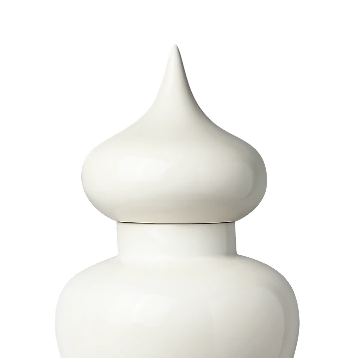 Close-up of the top part of a white ceramic jar with a pointed lid.