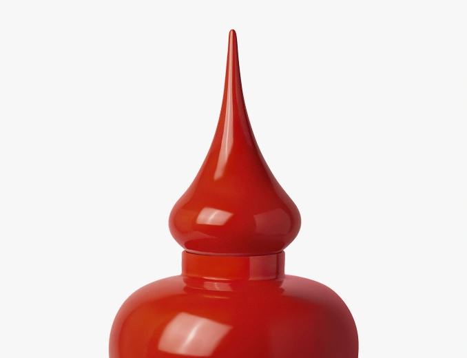 Glossy red ceramic container with a pointed, bulbous lid against a white background.
