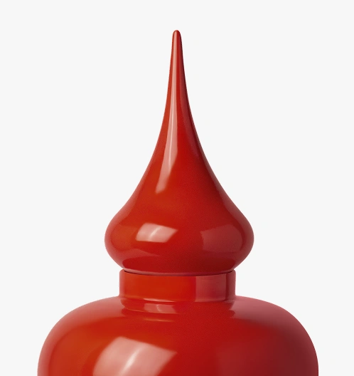 Close-up of a glossy red decorative finial with a pointed top against a white background.