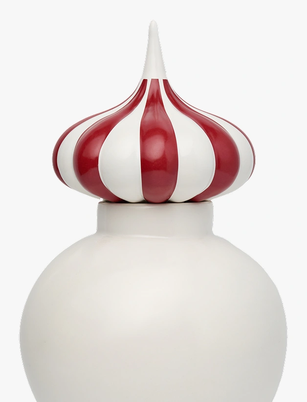 White ceramic container with a lid shaped like a red and white striped pointed onion dome.