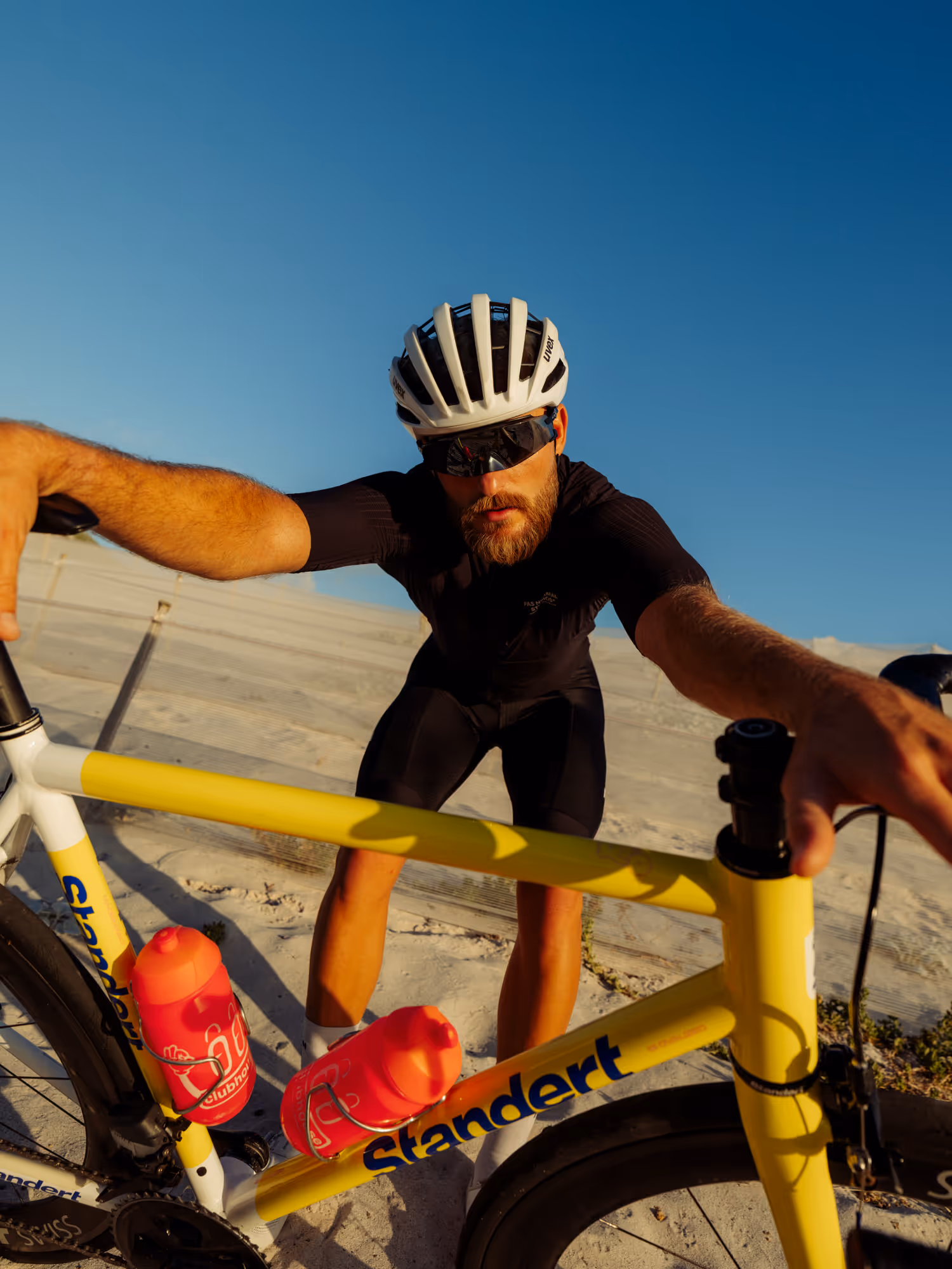 Man posing on a bike to camera