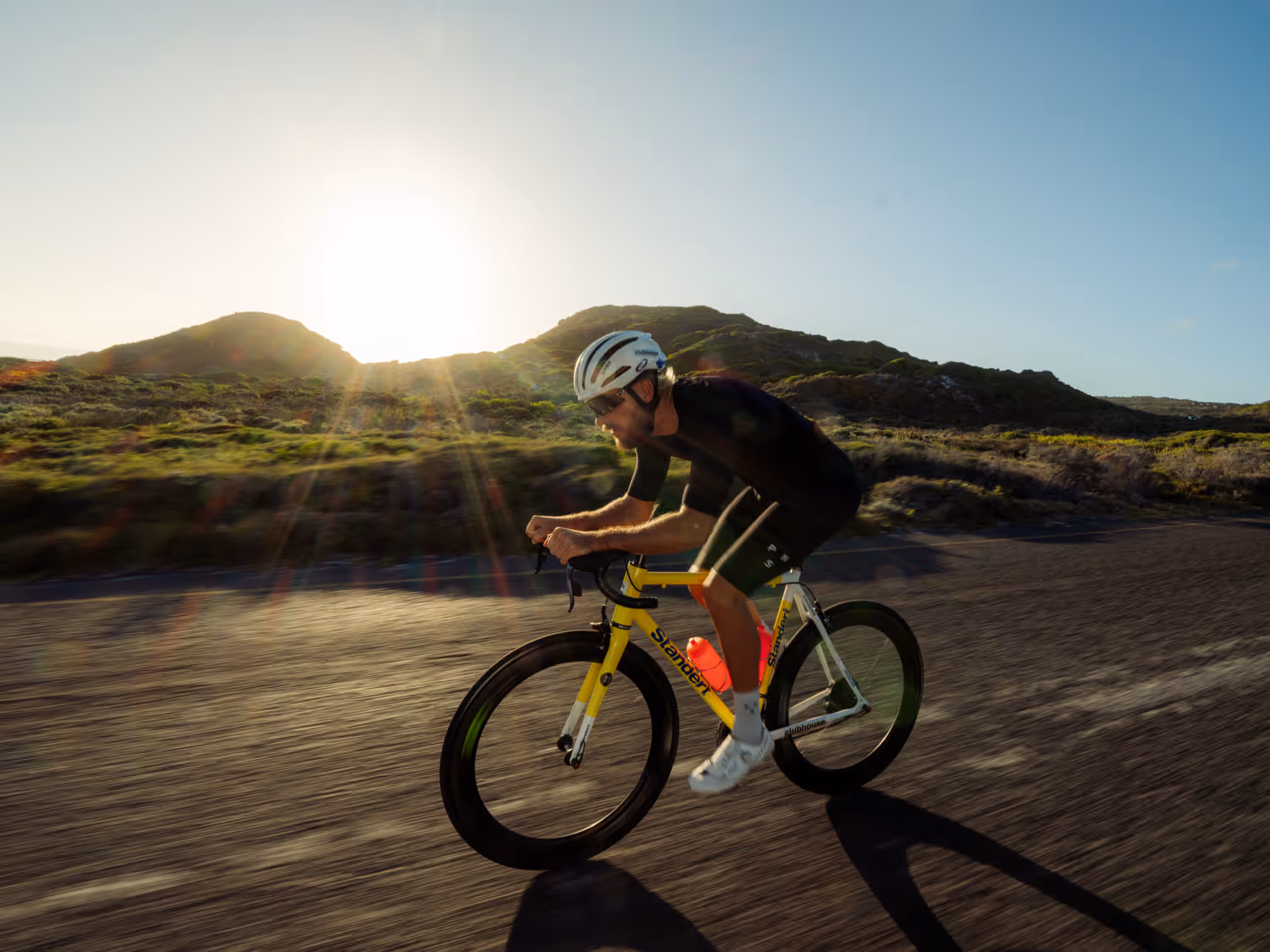Action shot of man cycling down road 