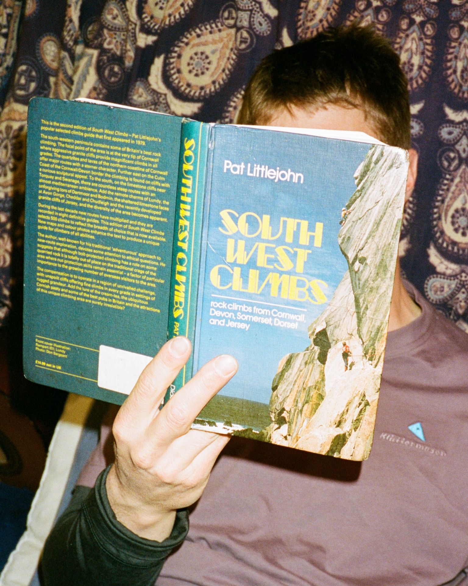 Man reading book on rock climbing