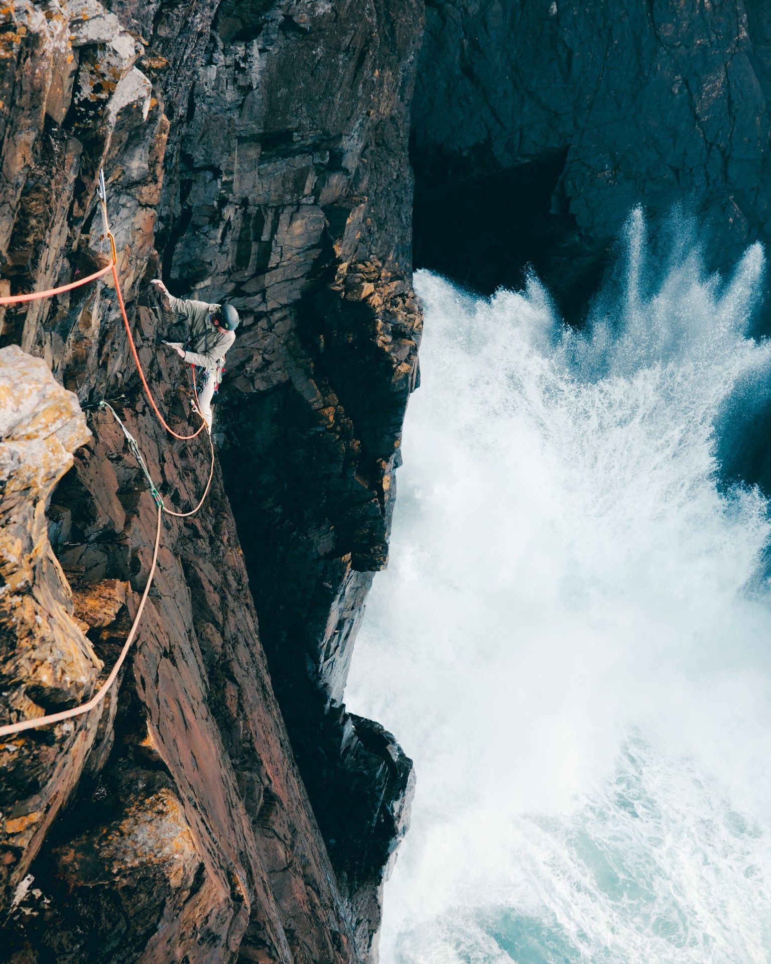 Man climbing above sea 