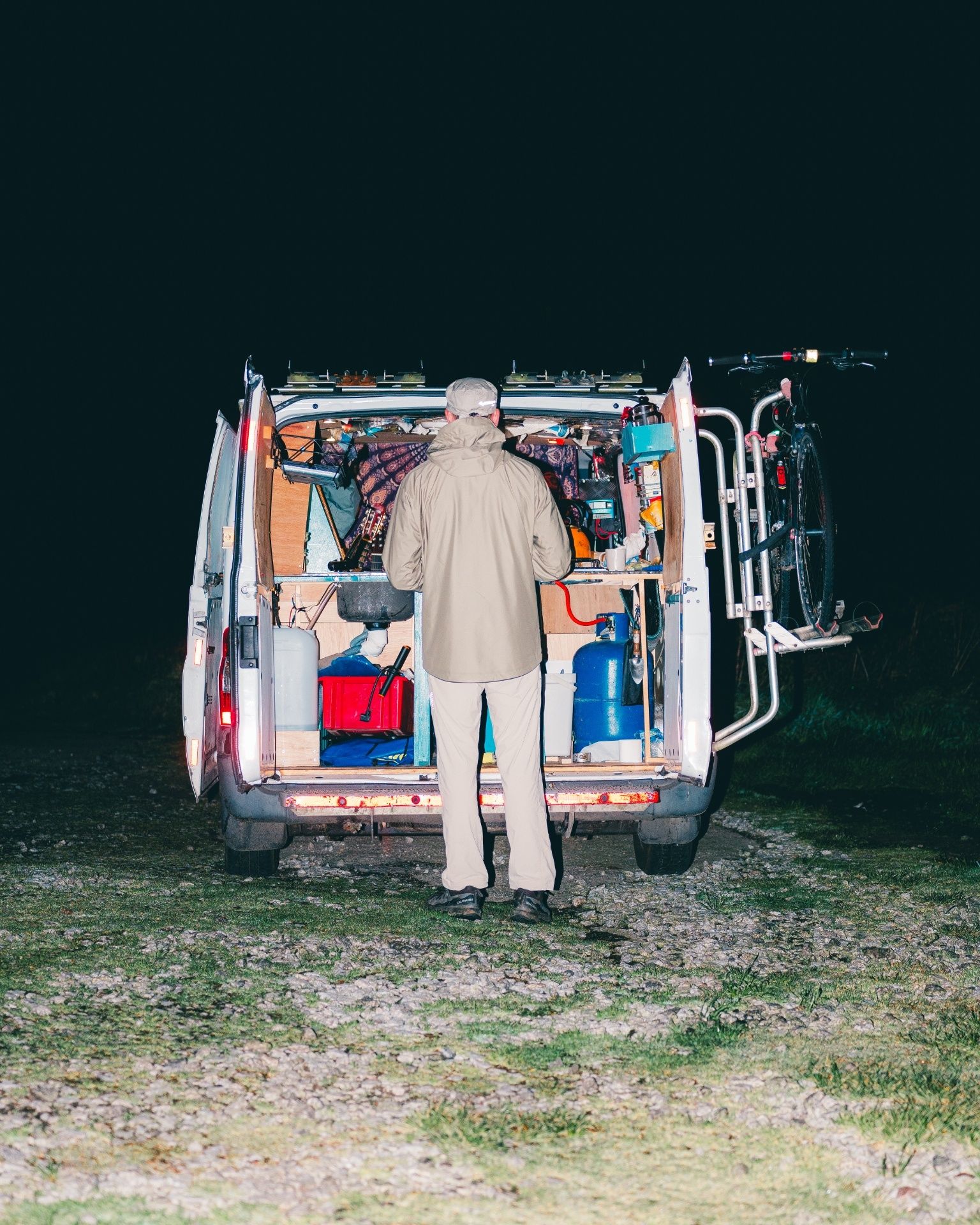 Man looking in back of van