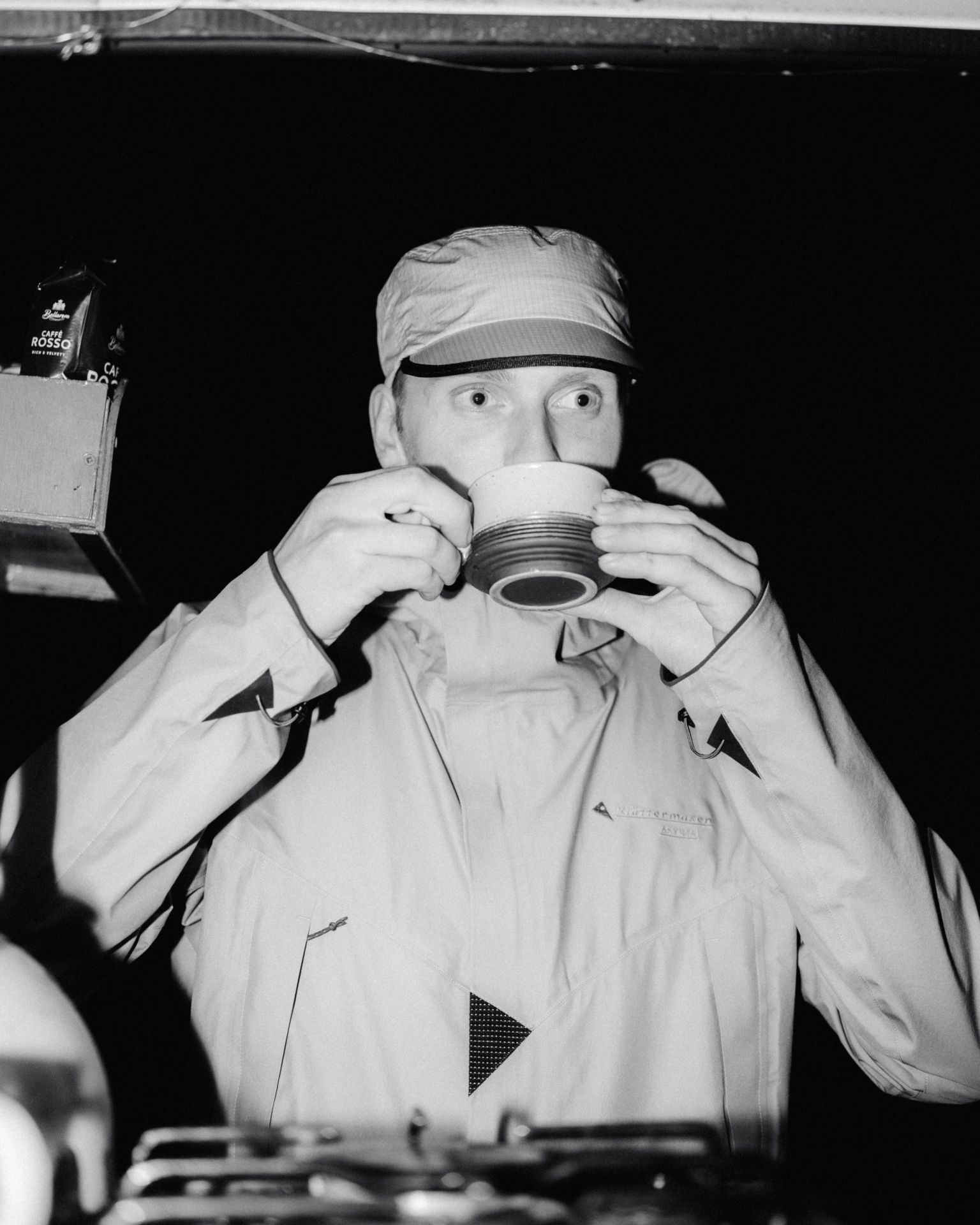 Black and white portrait of man drinking from cup