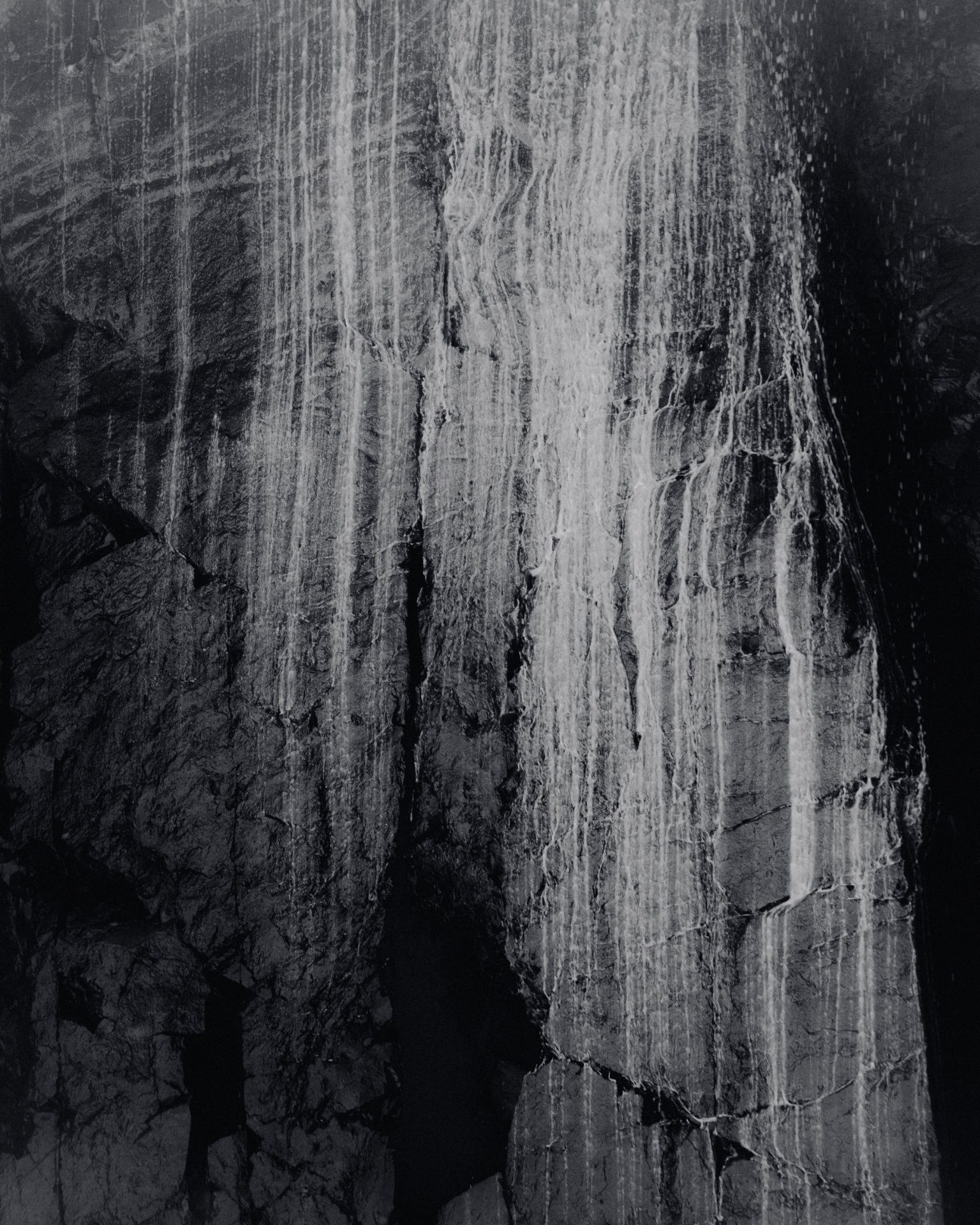 black and white close up of cliff face
