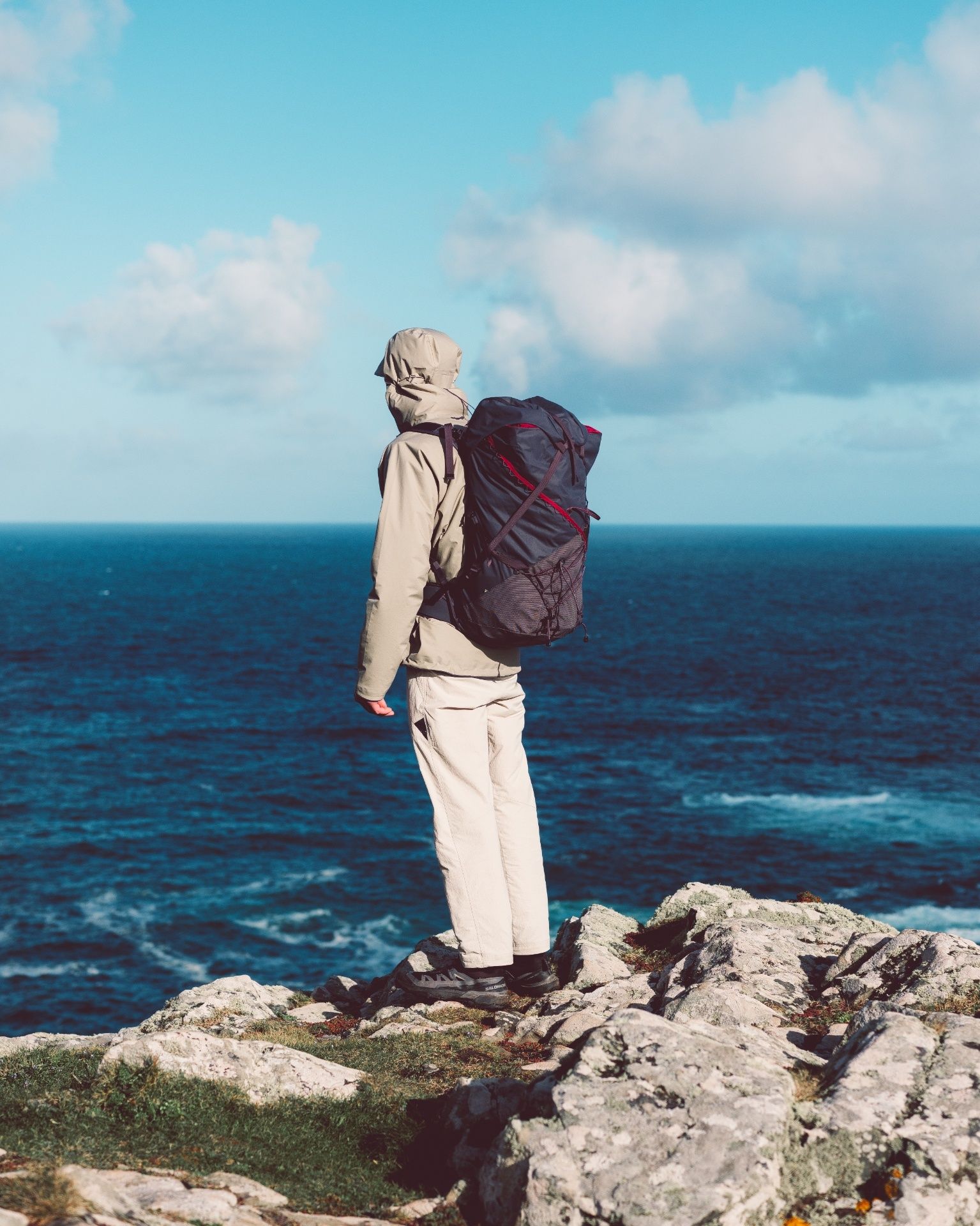 Man looking out to see from a rock