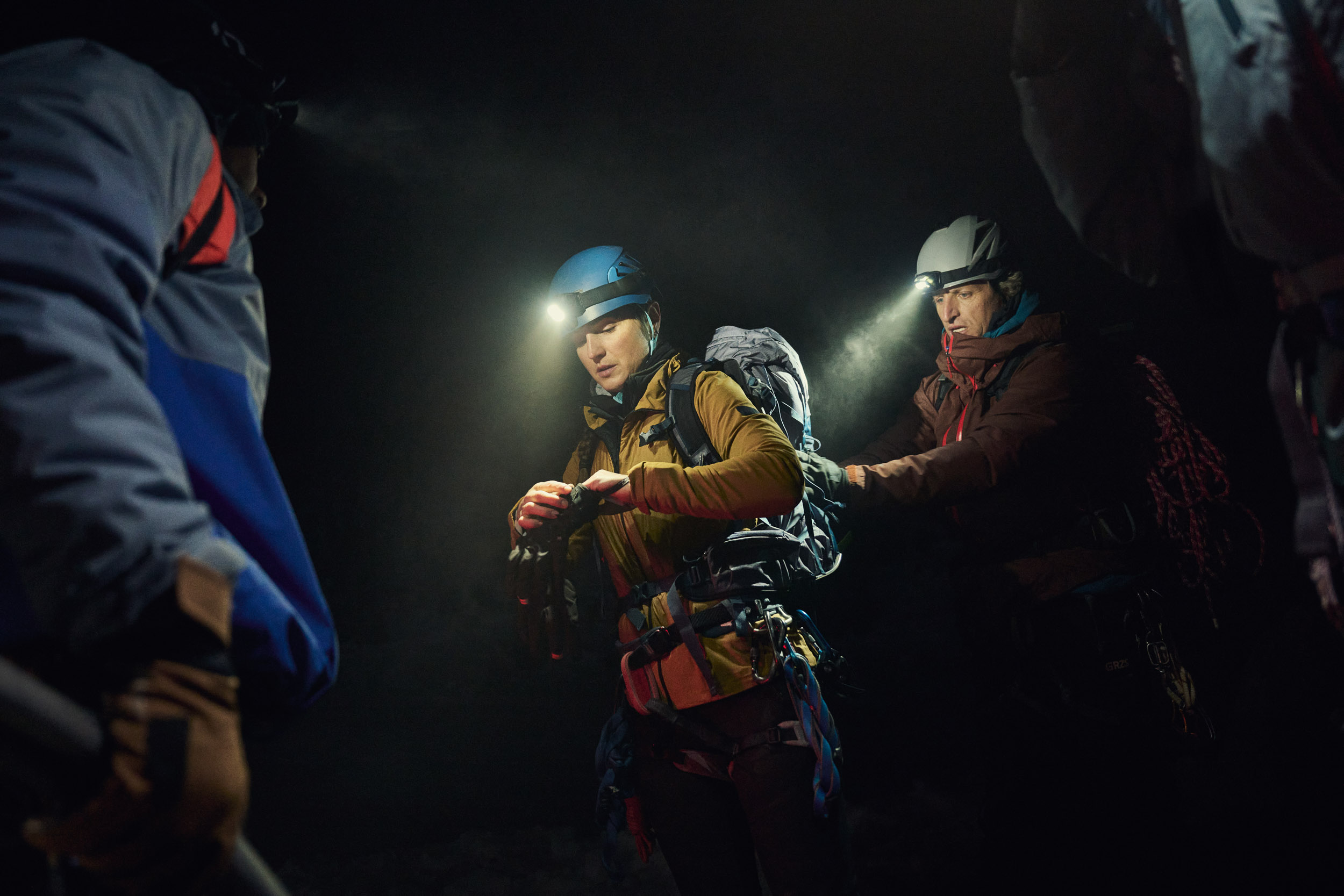 Climbers with head torch on at night