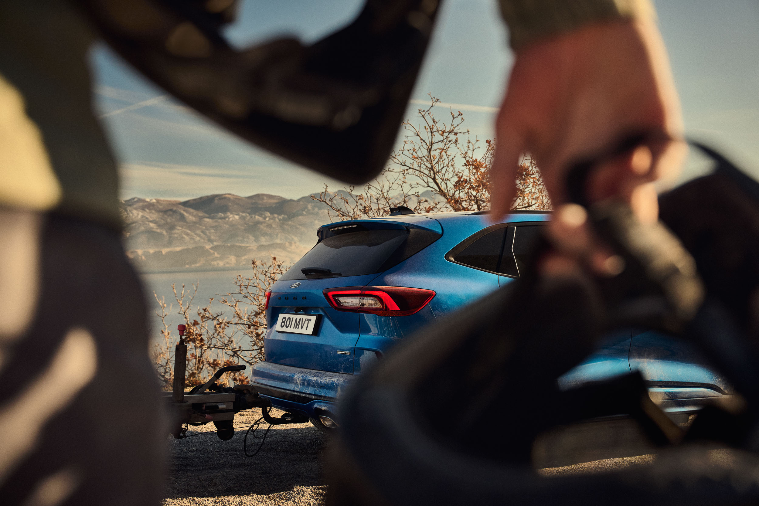 Shallow depth of field image of car through someone's arm 
