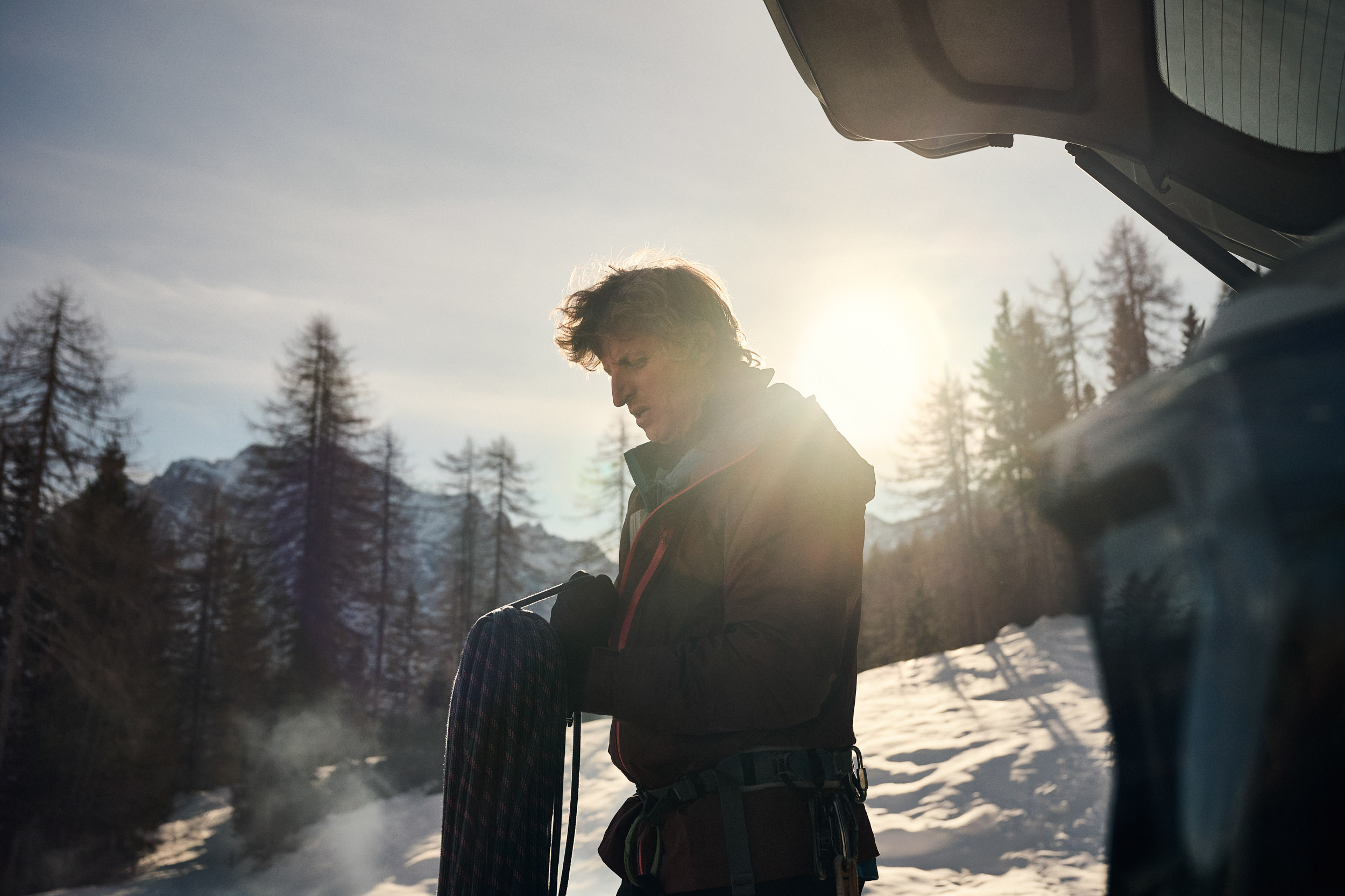 Hiker in front of bright sun 