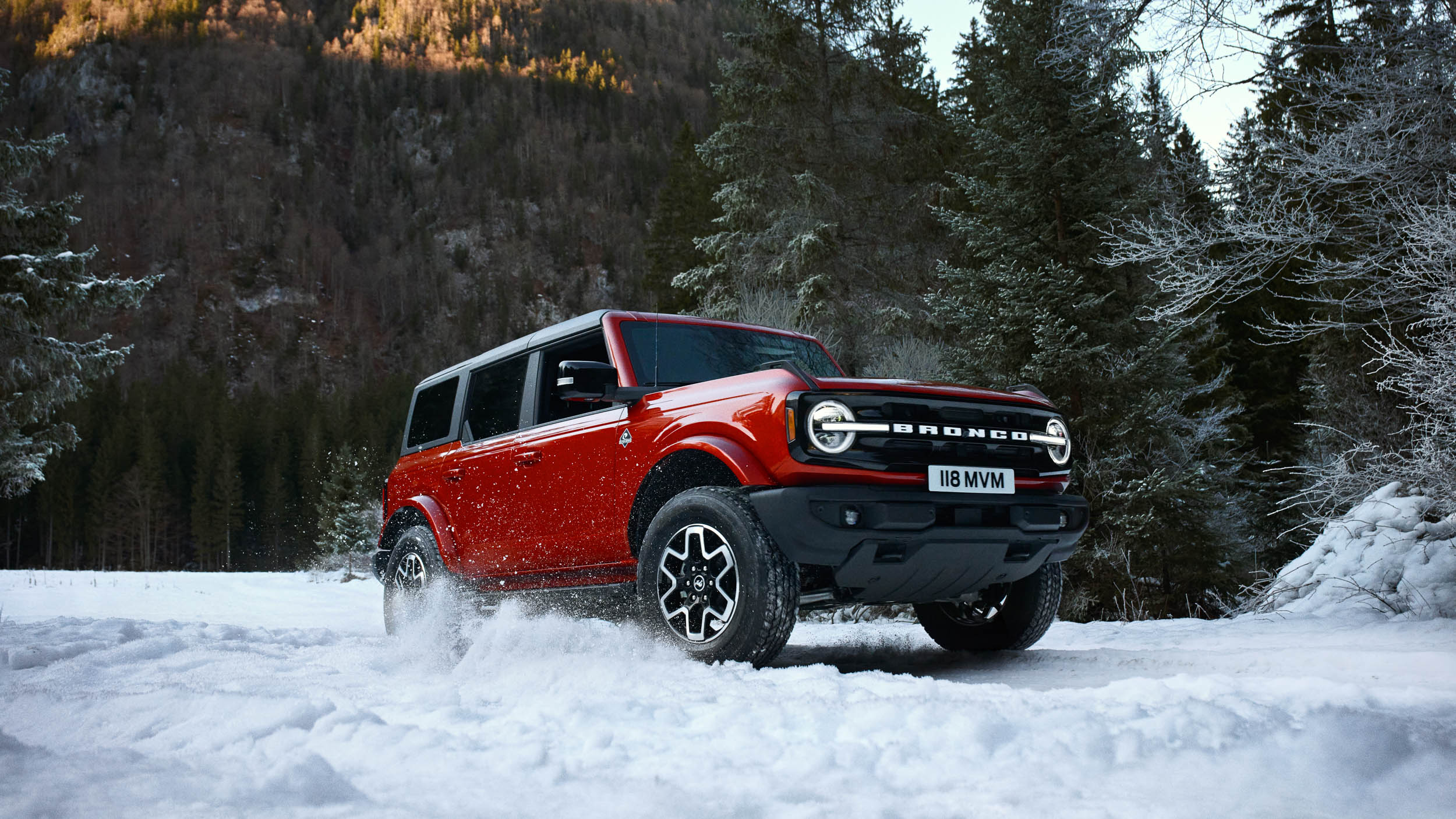 Red Ford SUV car in snowy mountain