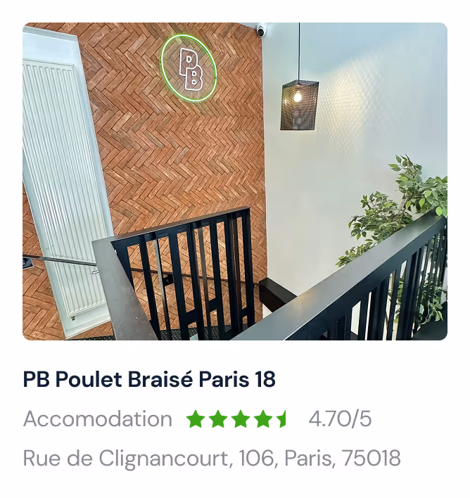 Exterior of The Sherlock Holmes Museum with illuminated vintage lamps and hanging flower baskets on a brick building.