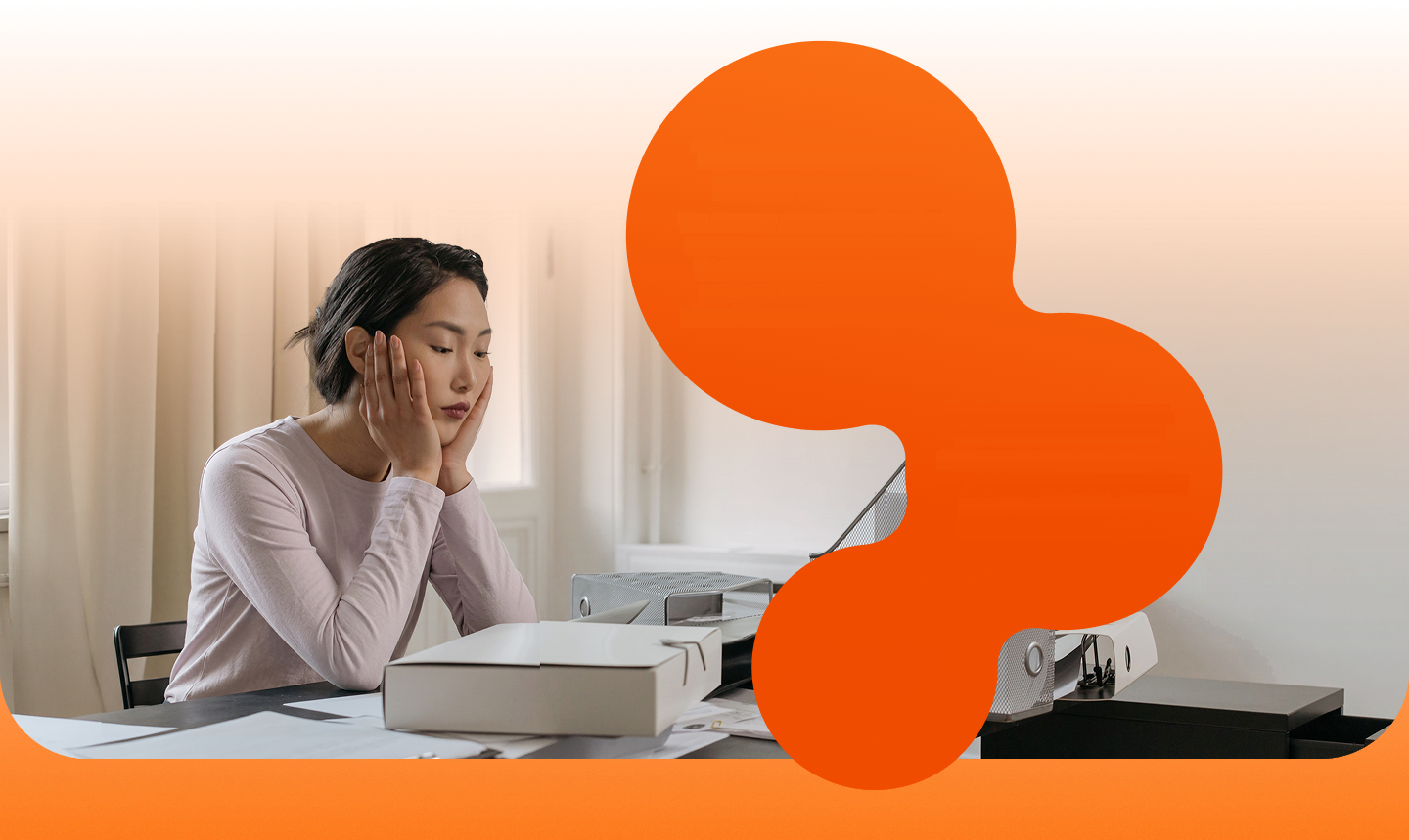 A renter at a desk among paperwork and a printer