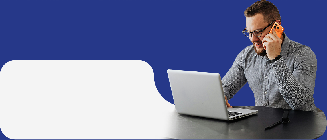 A landlord on the phone while working on a laptop