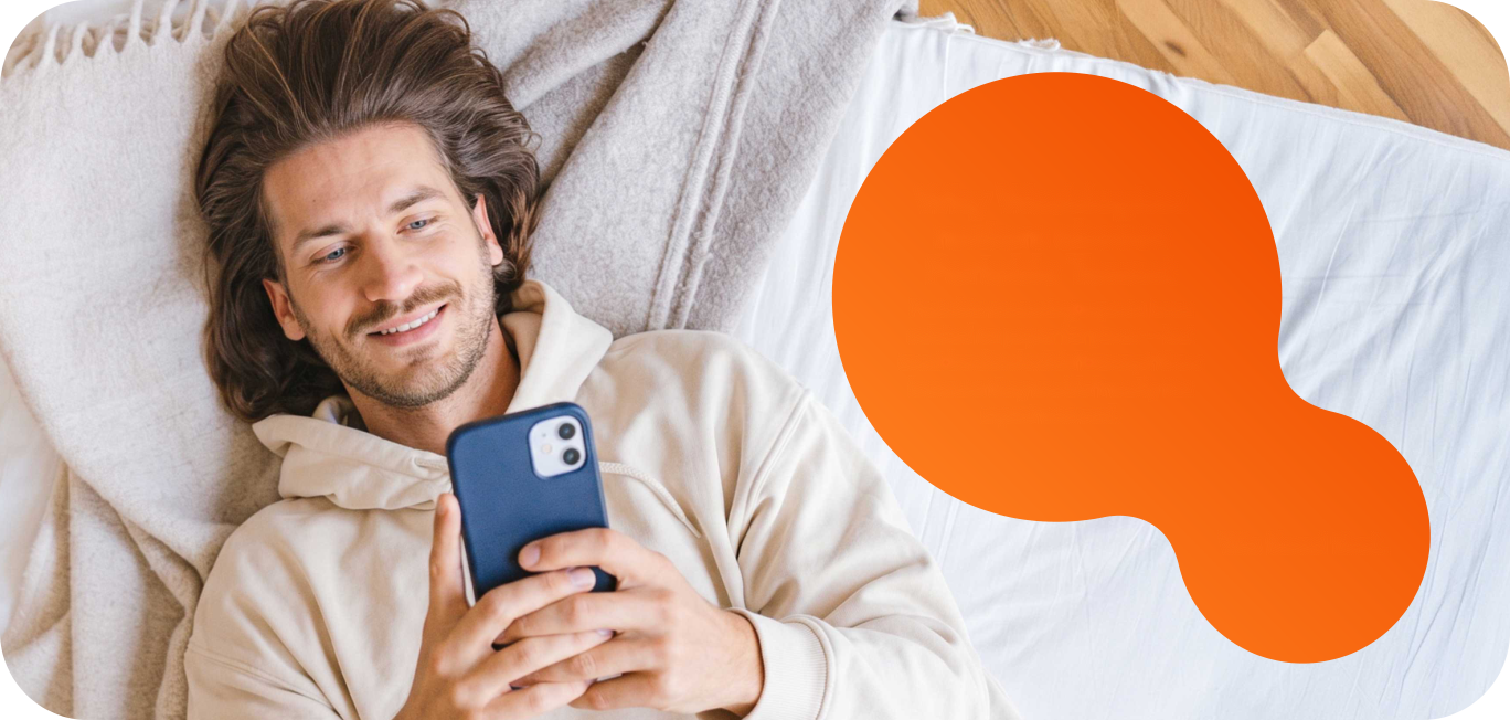 A renter lying down, smiling at their phone