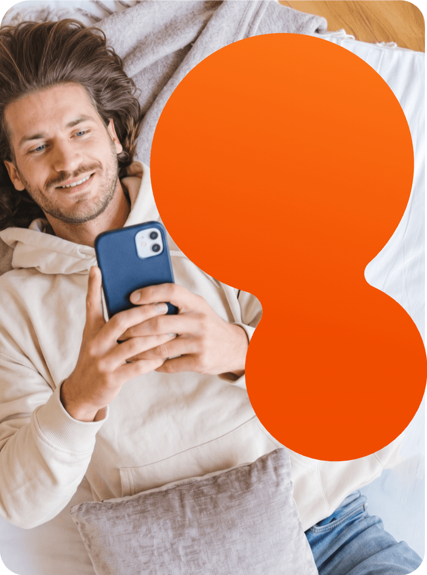 A renter lying down, smiling at their phone