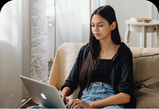 A renter on a sofa with a laptop