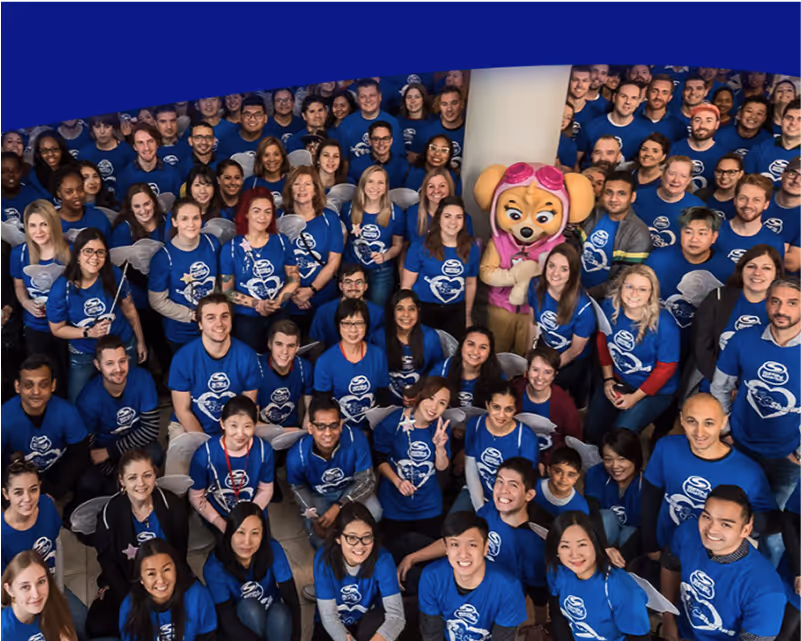 Spin Master group of people wearing matching blue shirts.