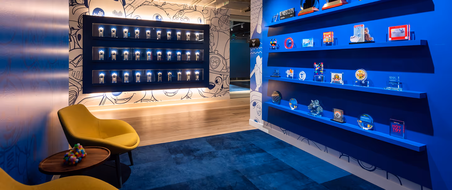 Spin Master headquarters with a cobalt blue wall filled with awards