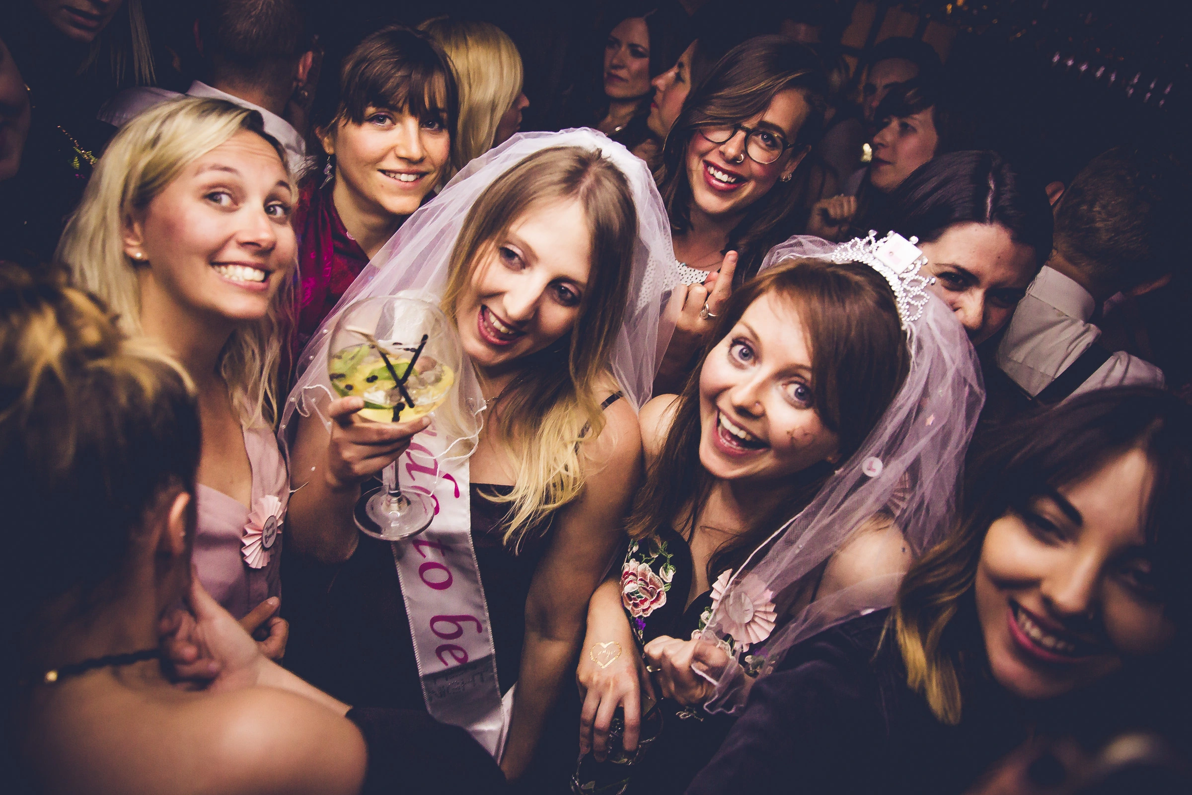 Group of friends celebrating a hen do with cocktails in Bath