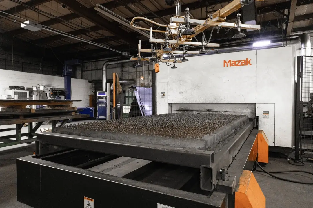 Champion 3015 Fiber Laser 3K cutting machine in a production facility.