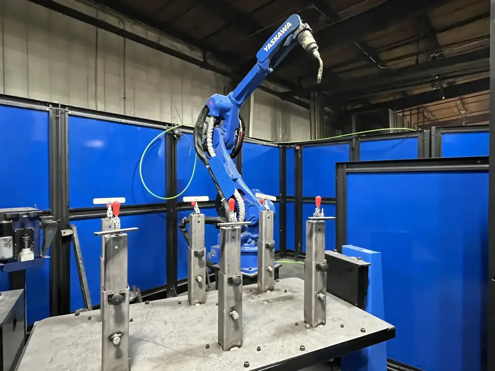 Capital Robotics Fusion Arc 200-L with Yaskawa robotic welding arm inside a blue enclosure.