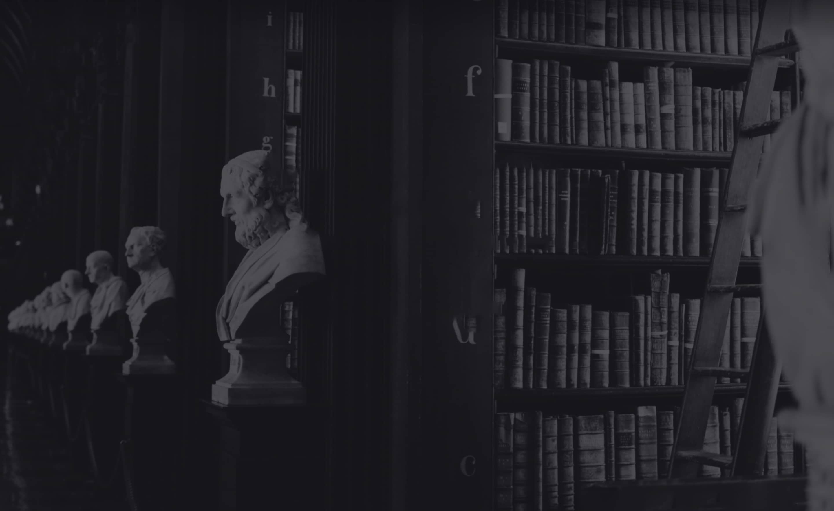 Symbolic image of justice – statues and legal books reflecting the firm’s expertise