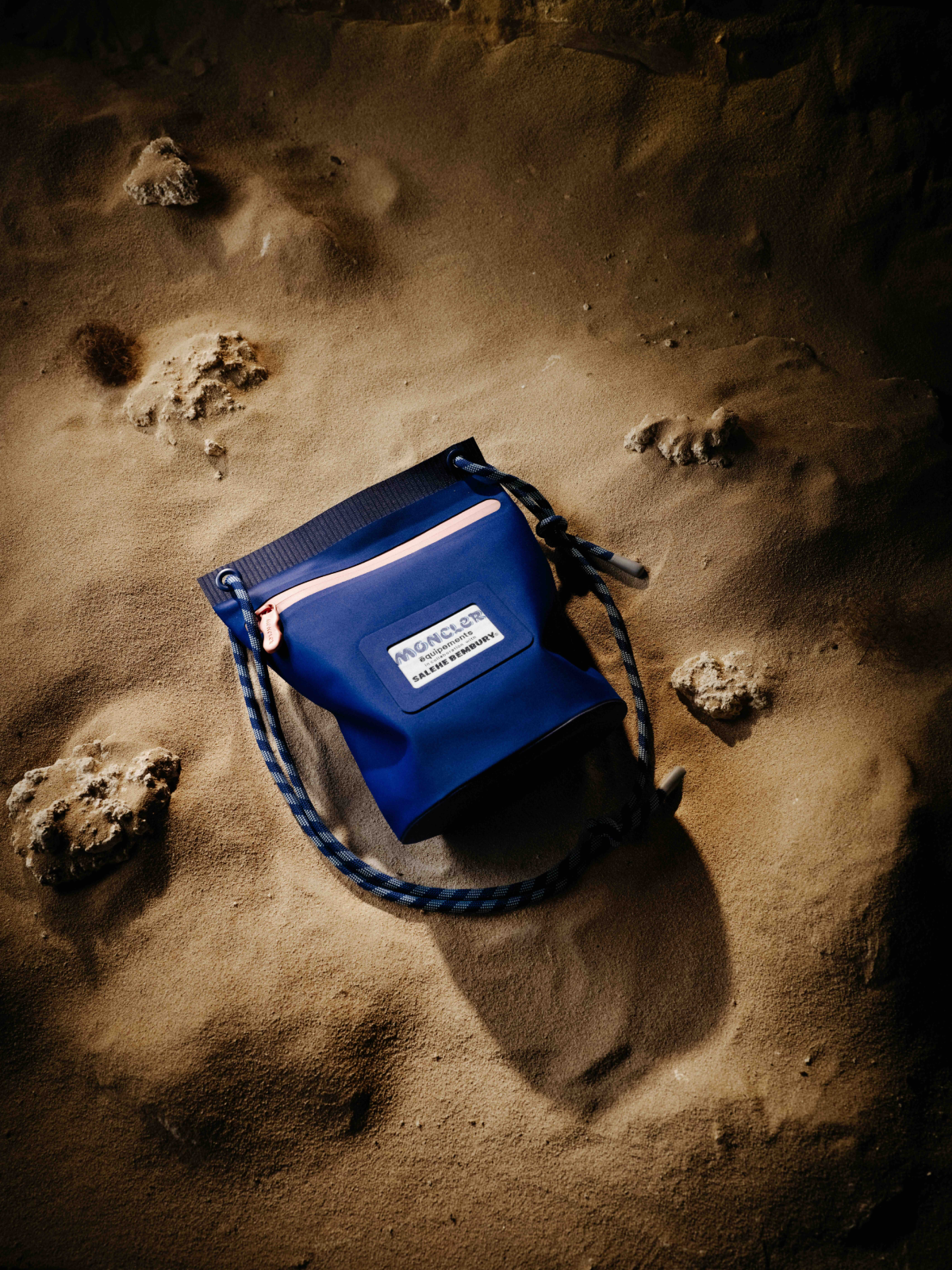 Cinematic still from RESH moncler campaign — wide frame with blue bag