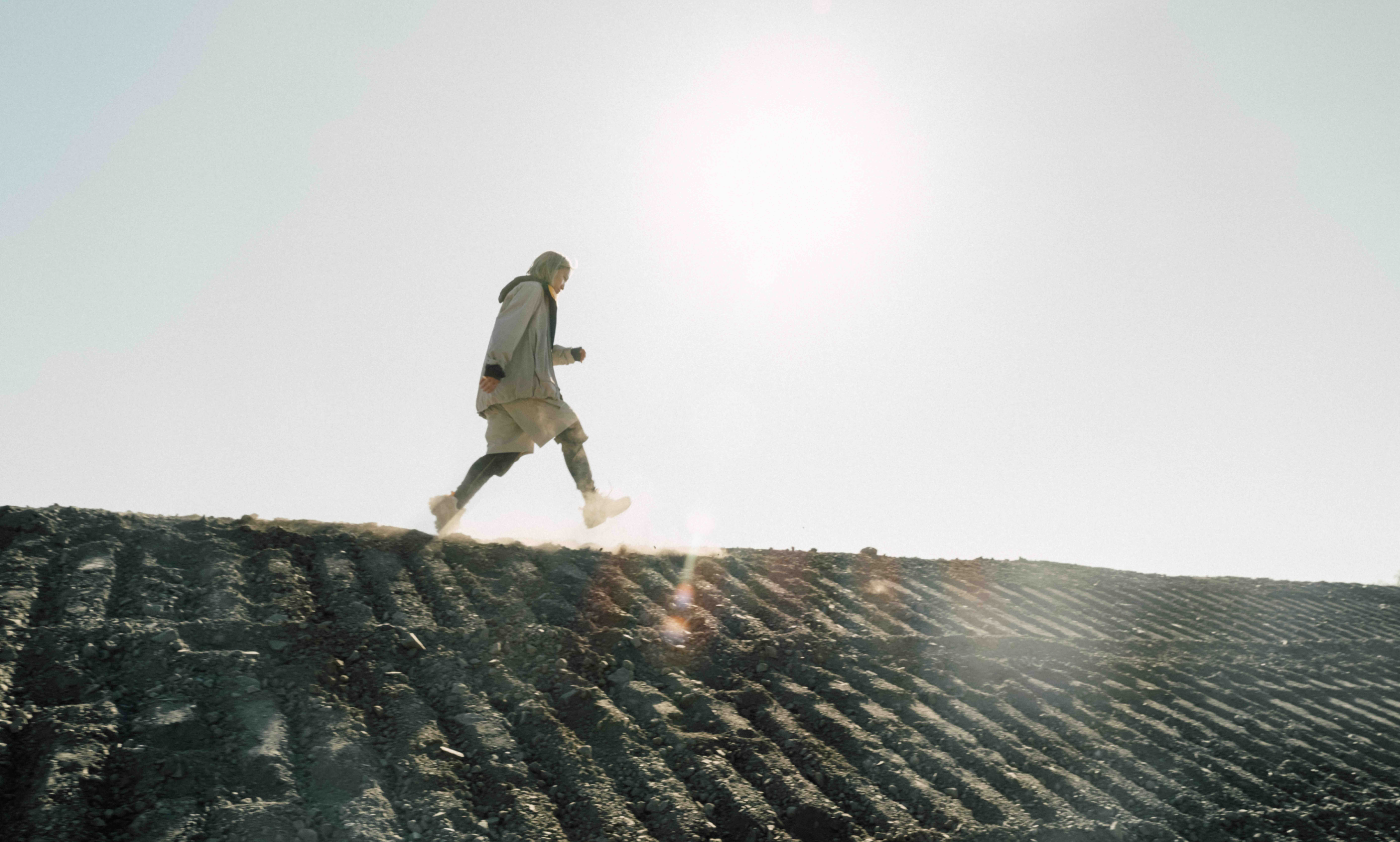 Cinematic still from RESH CAT Footwear commercial film — close-up portrait with dramatic lighting