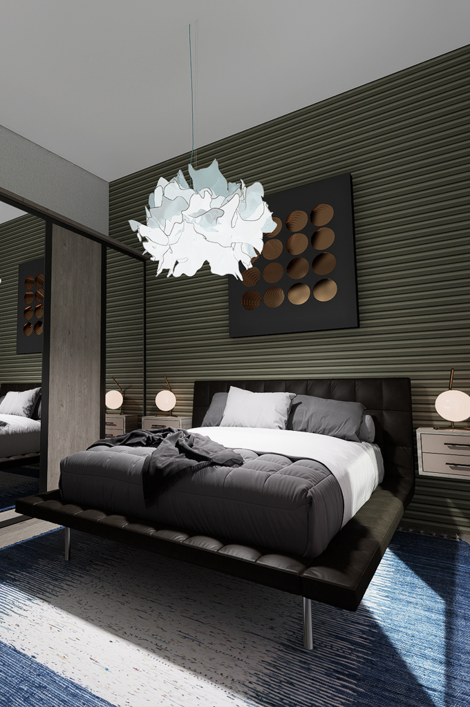 Modern bedroom with a black leather platform bed, gray and white bedding, abstract pendant light, and textured green accent wall with circular wall art.