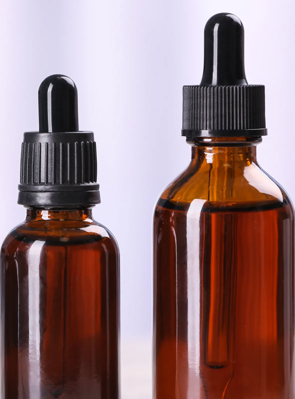 Two amber glass dropper bottles for liquid botanical extracts