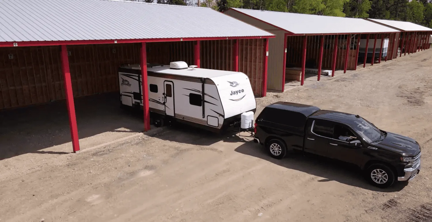 Black truck backing into storage unit