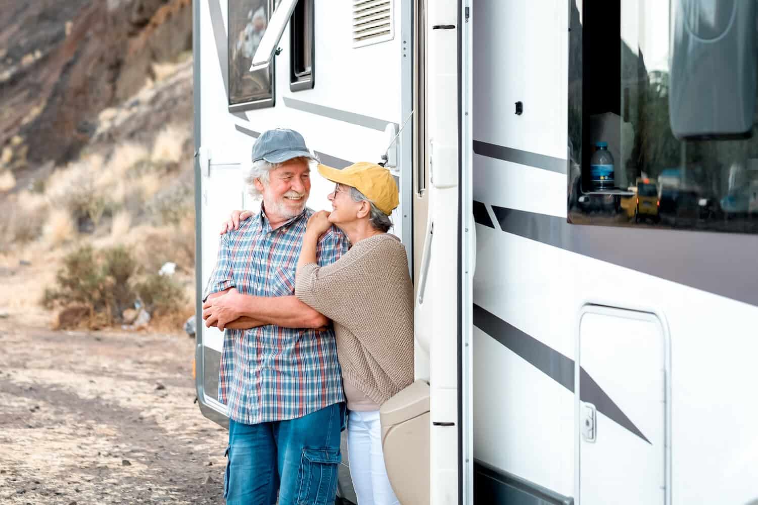Elderly couple standing outside an RV