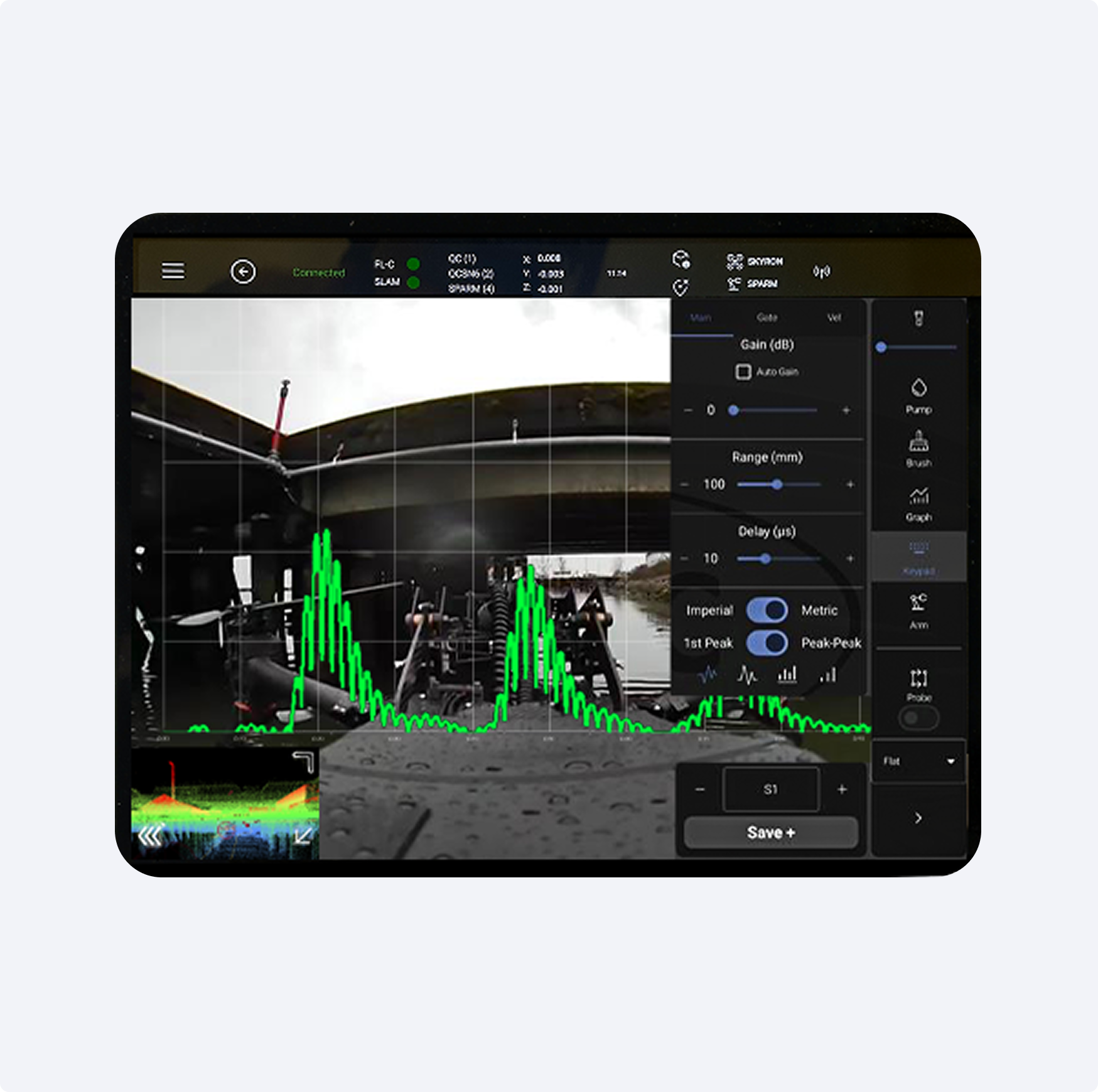 User interface screen showing a waveform graph with settings for gain, range, and delay over a background image of an outdoor industrial structure.
