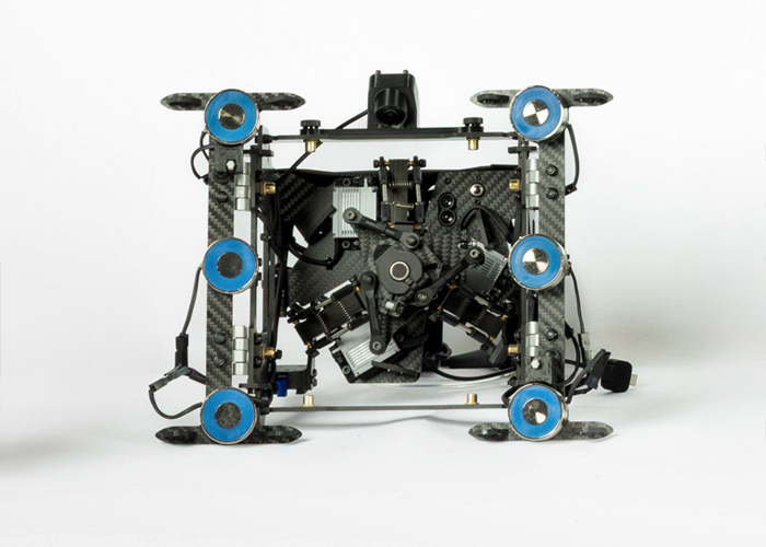 Avestec Overhead view of a compact four-wheeled robotic platform with carbon fiber frame and electronic components.
