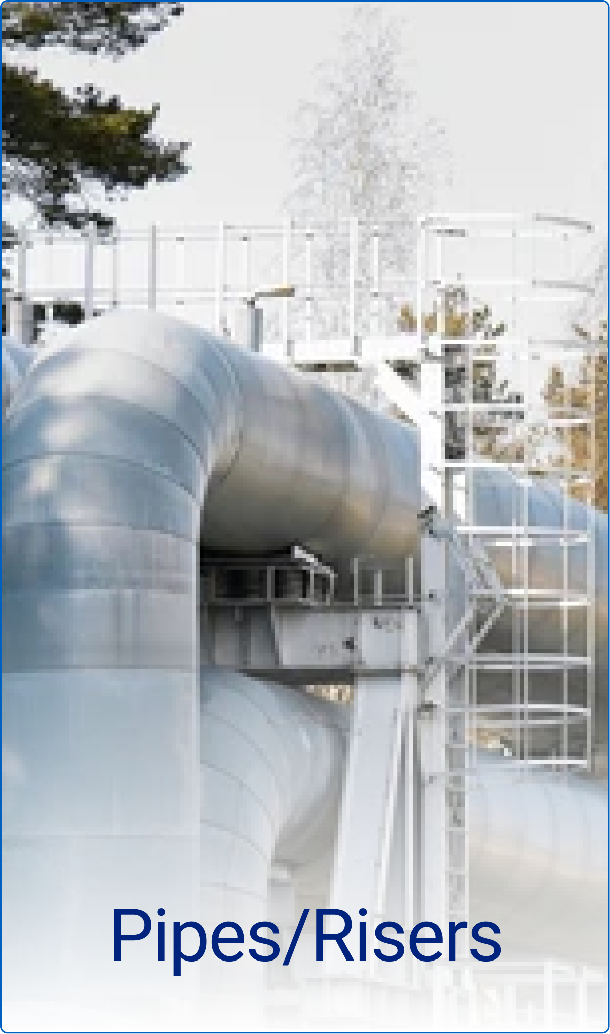 Large industrial metal pipes with support structures and a safety ladder outdoors.